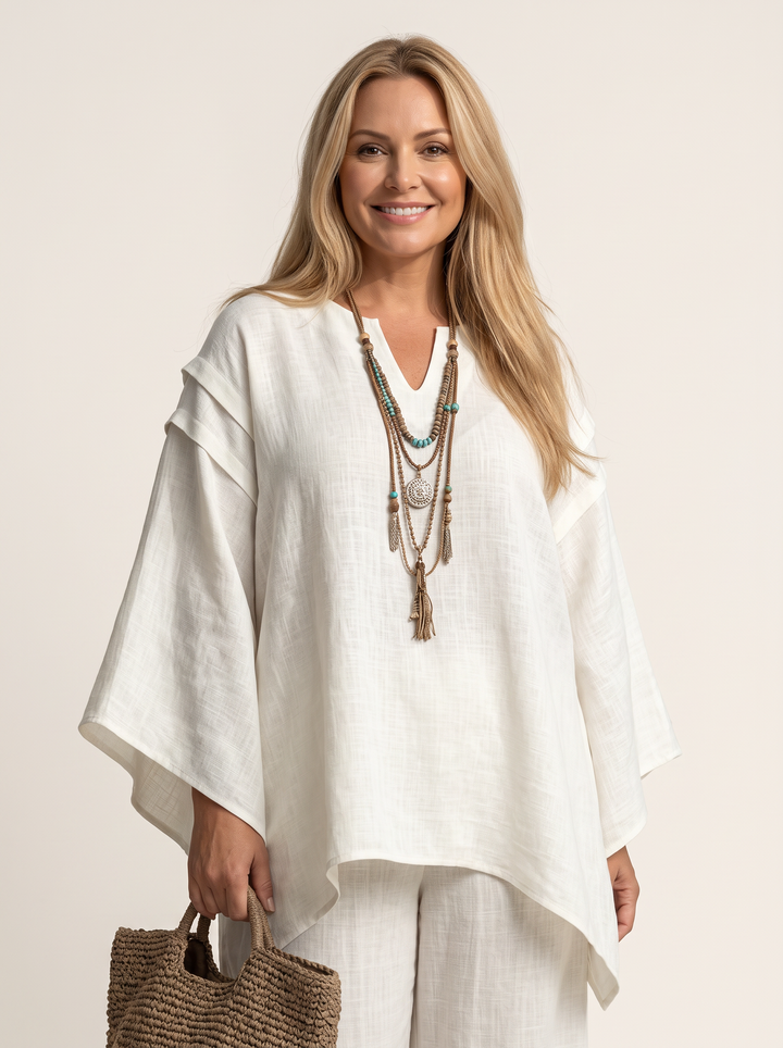 Close detail of the V neckline and cape sleeve